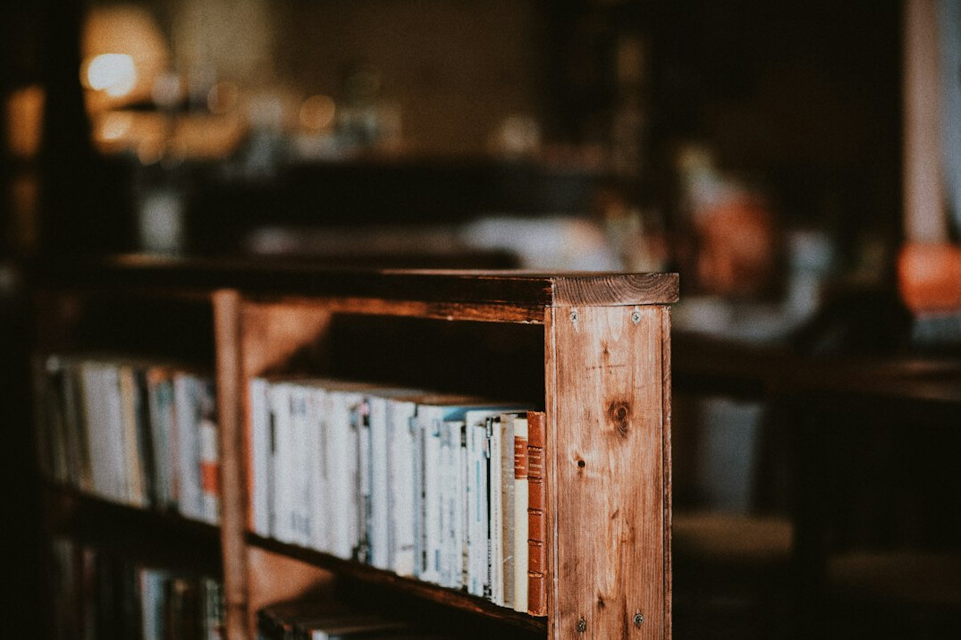 Wooden bookshelf filled with books in a quiet library