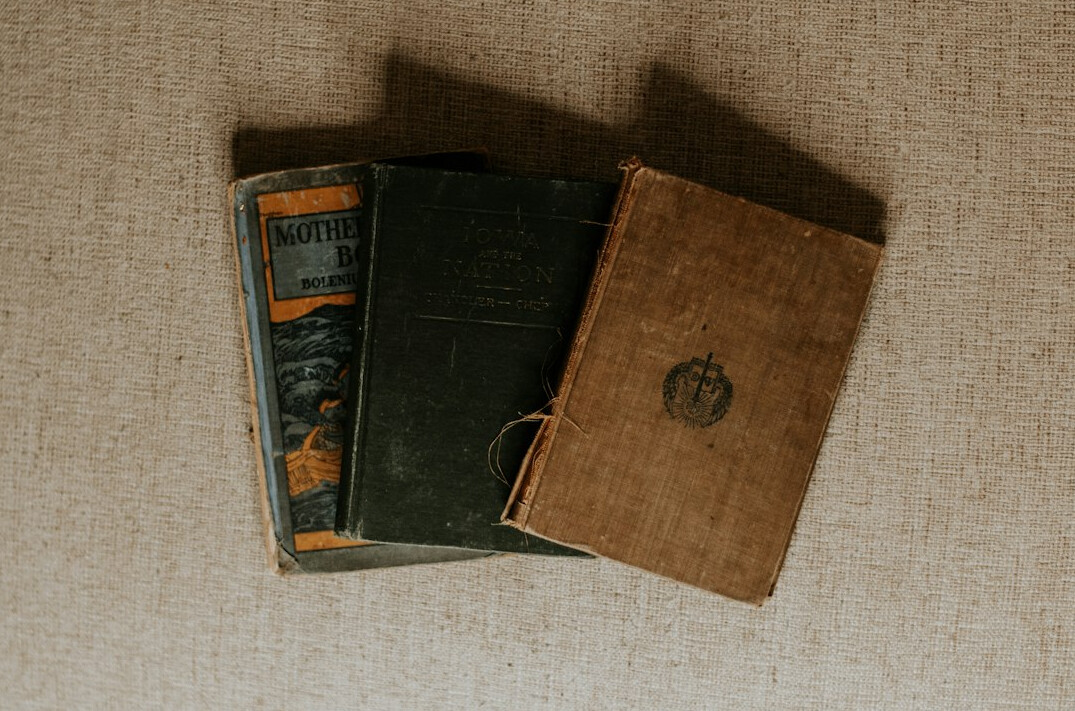 Old books with worn covers on a table