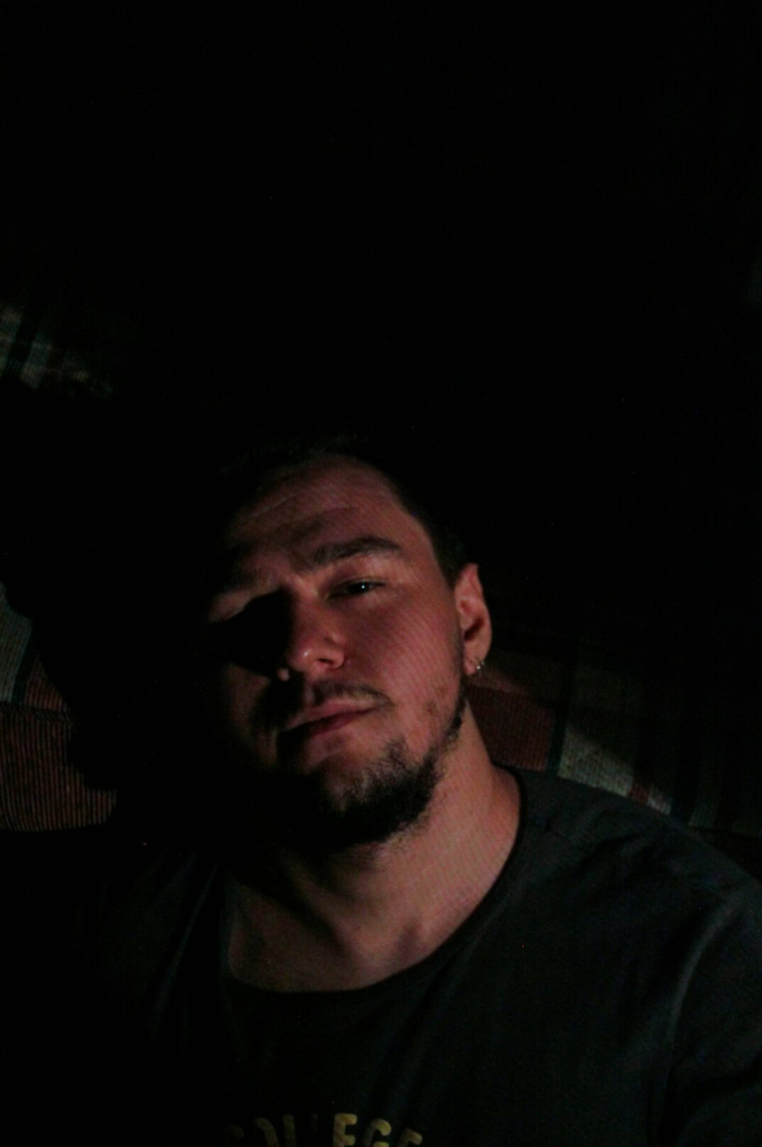 Portrait of a man with a short beard looking at the camera