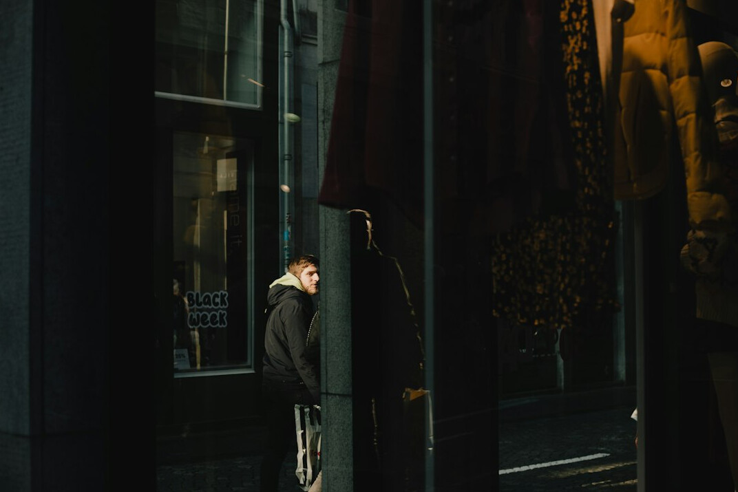 woman hiding item under coat